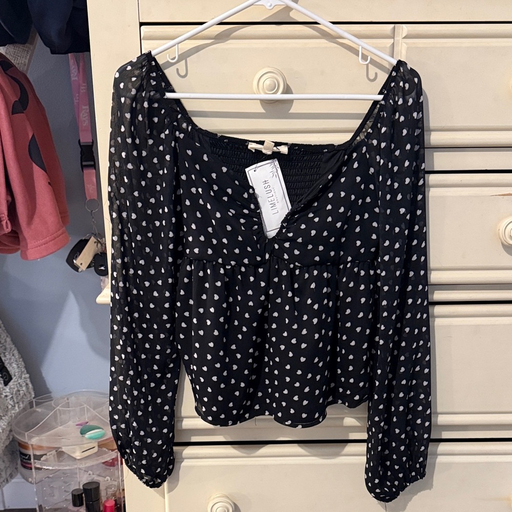 LimeLush (Boutique) Black Blouse with White Heart Pattern. See-through sleeves